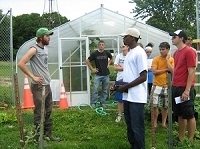 students in discussion at the SAP farm green house